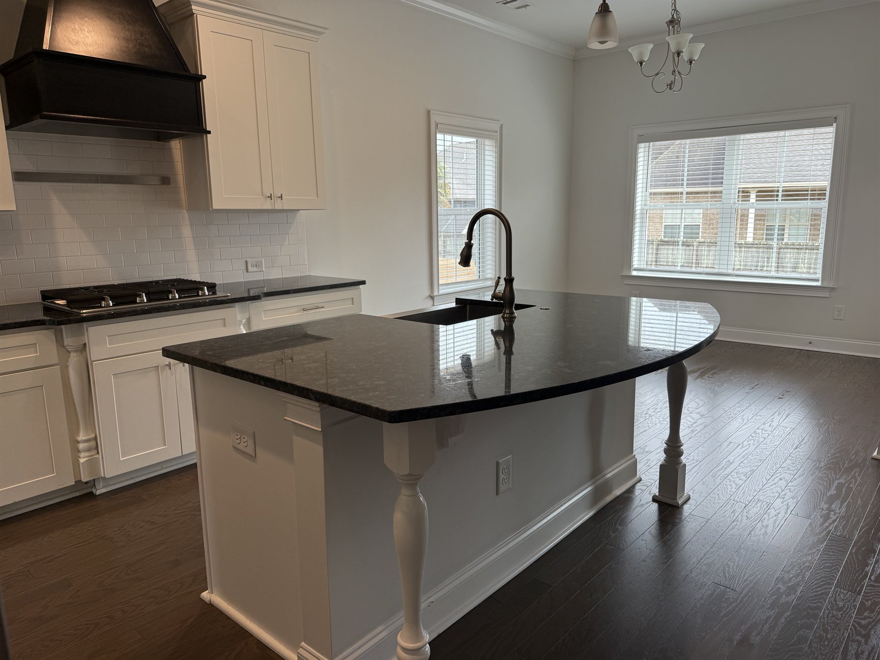 Whole-home cleaning result &mdash; bright kitchen and living room with polished floors