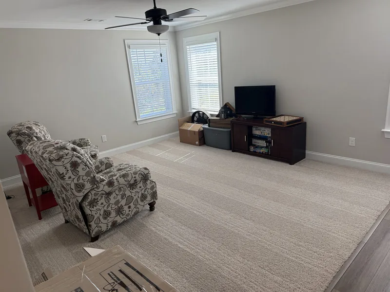 Professional residential cleaning result &mdash; bright living space with vacuumed carpet and tidy finish