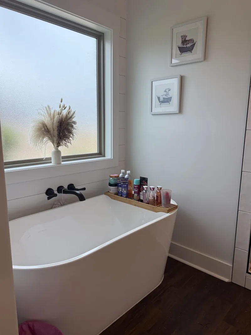 Luxury bathroom deep clean &mdash; tub area with polished fixtures and organized products