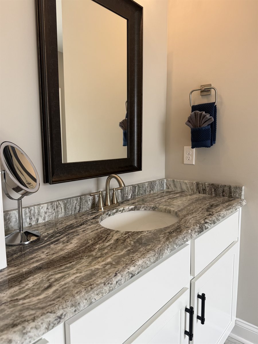 Bathroom vanity detail cleaning &mdash; polished countertop and spotless sink