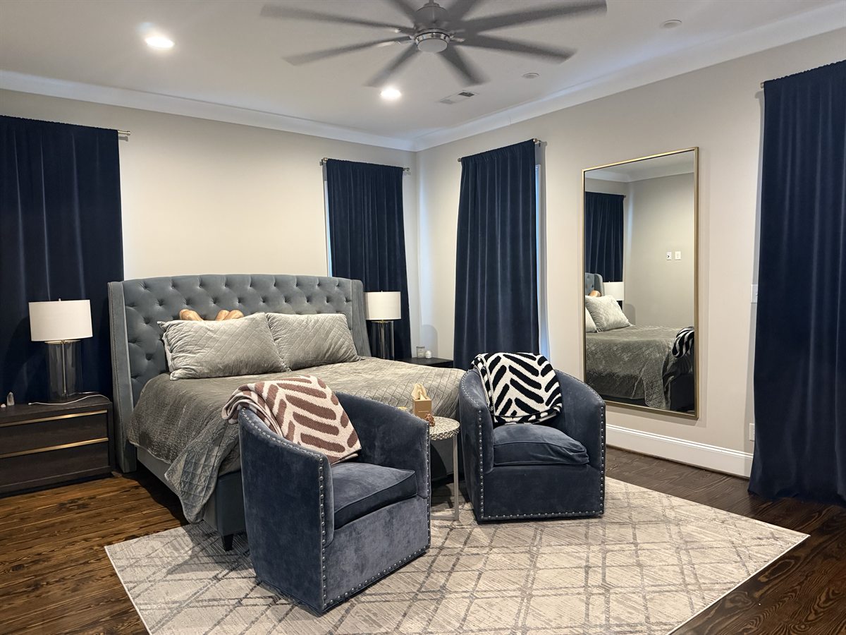 Bedroom reset after Haven Home cleaning &mdash; staged seating and polished hardwood floors